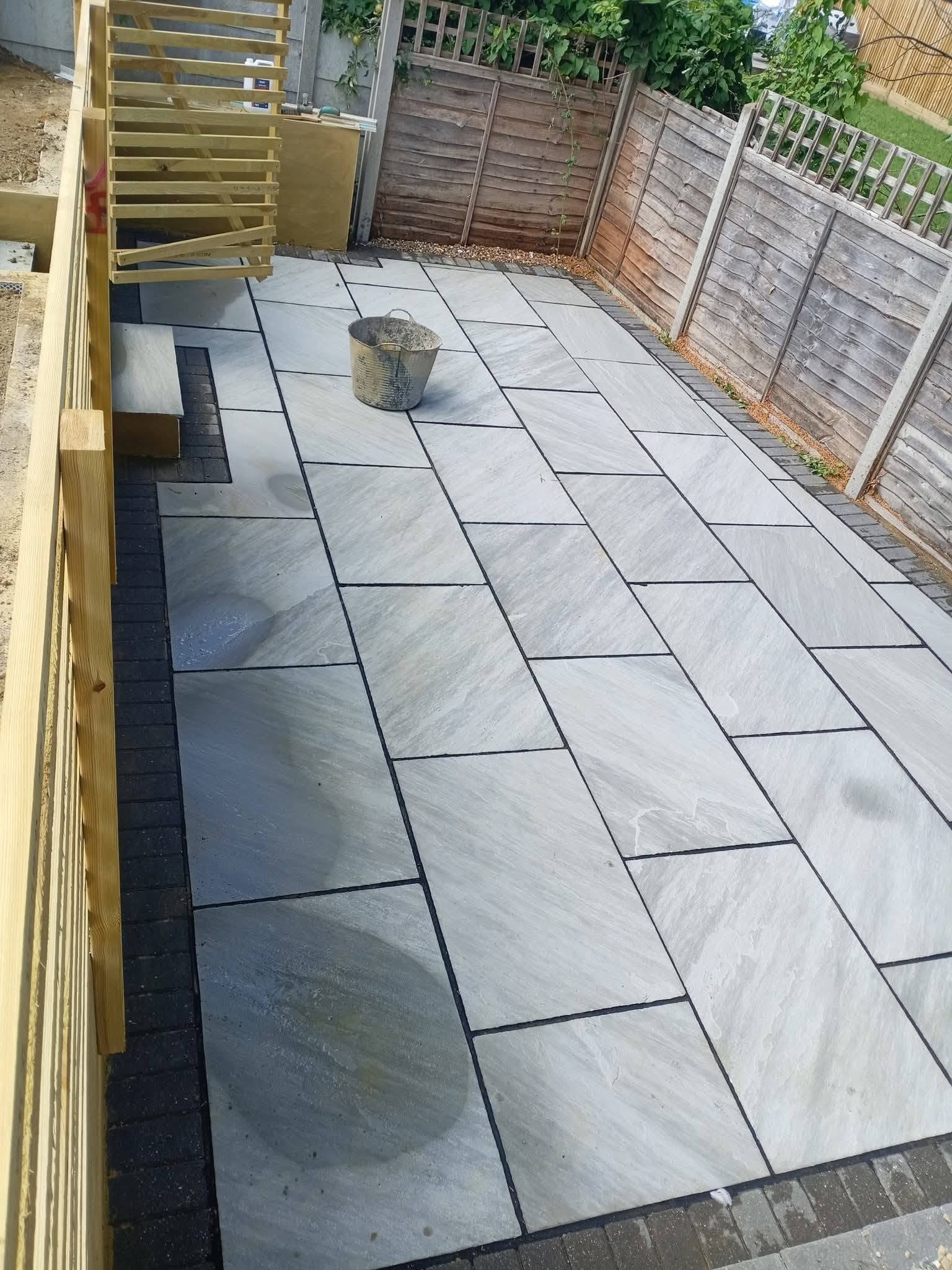 Grey Indian sandstone patio with charcoal border